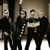 U2, primiti cu proteste in orasul natal